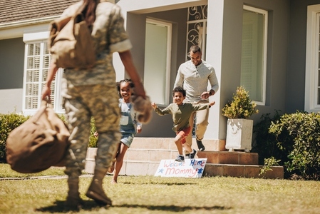 Soldier being welcomed by her family at home