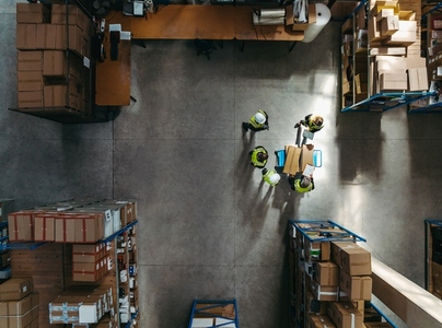 Top view of warehouse workers having a discussion during a meeting
