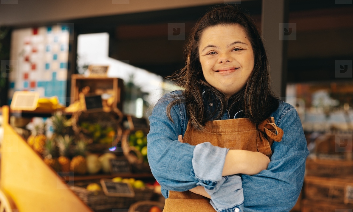 Shop employee with Down syndrome smiling at the camera
