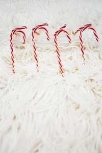 Christmas background doing with classic candy canes over a soft