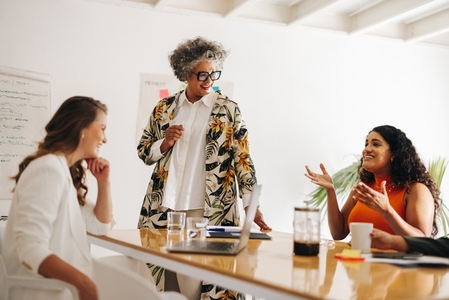 Cheerful businesswomen having a discussion in a boardroom