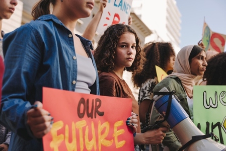 Teenage girl holding a megaphone during a climate change protest
