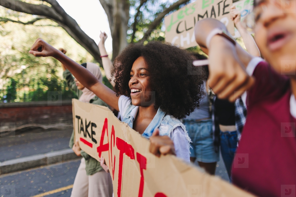 Cheerful young people standing up against climate change