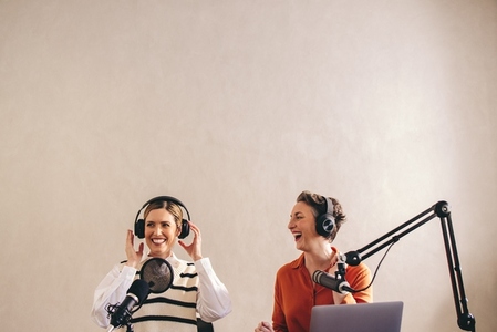 Female radio presenters having a good time on a live broadcast