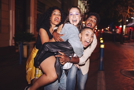 Crazy friends having fun together in the city