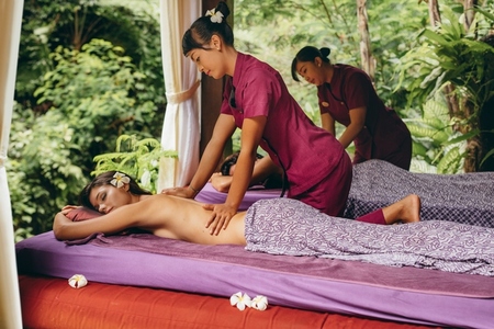 Couple having body massage at luxury resort spa center
