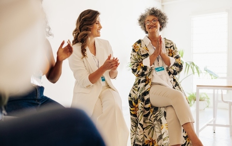 Successful businesswomen applauding during a conference meeting