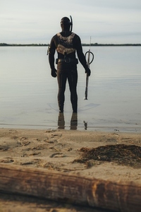 Male diver going spearfishing in the sea water