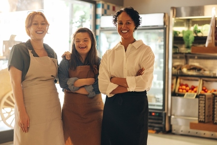 Group of diverse retail workers smiling happily in a grocery store