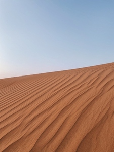 Minimalist shot of a dune against sky in desert