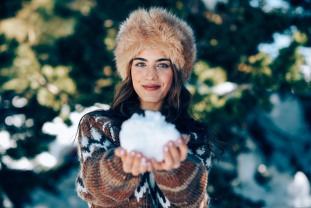 Young woman enjoying the snowy mountains in winter