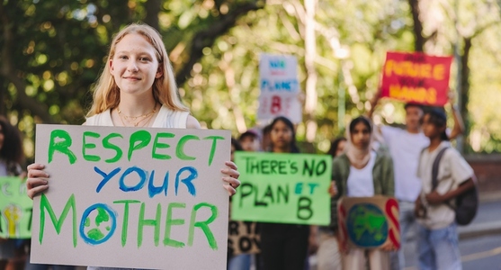 Happy teenage girl leading a march against global warming