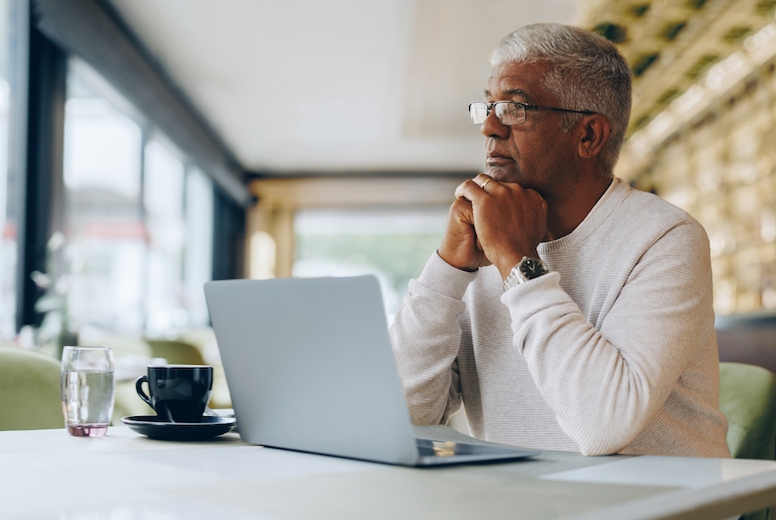 Thoughtful businessman working in a cafe