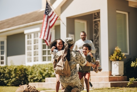 Servicewoman embracing her children on her homecoming