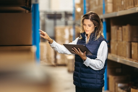 Female supervisor using a digital tablet in a warehouse