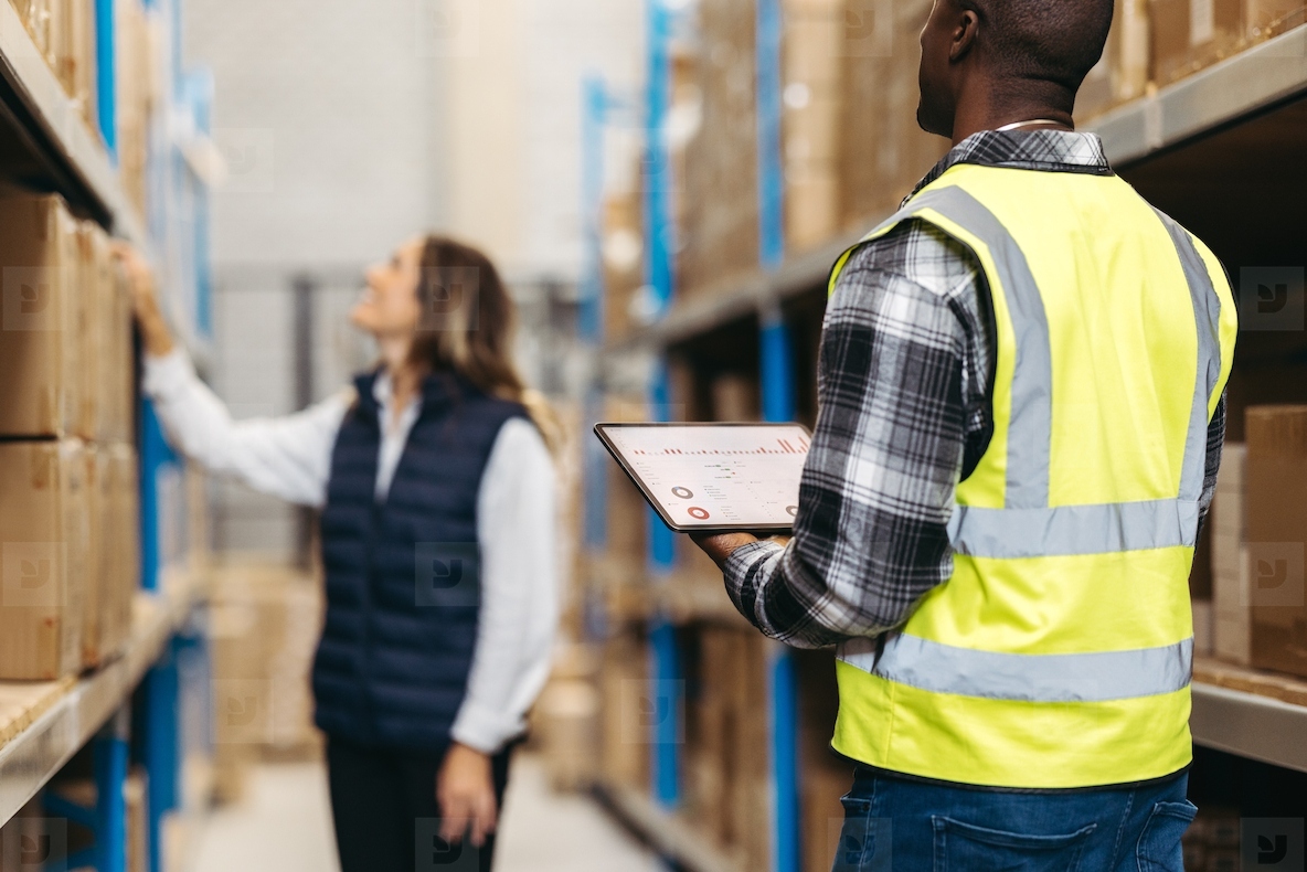 Warehouse workers using warehouse management software