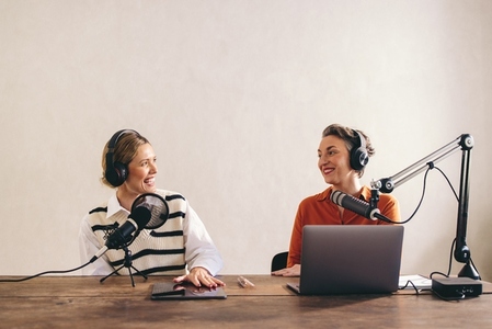 Female content creators recording a podcast in a home studio