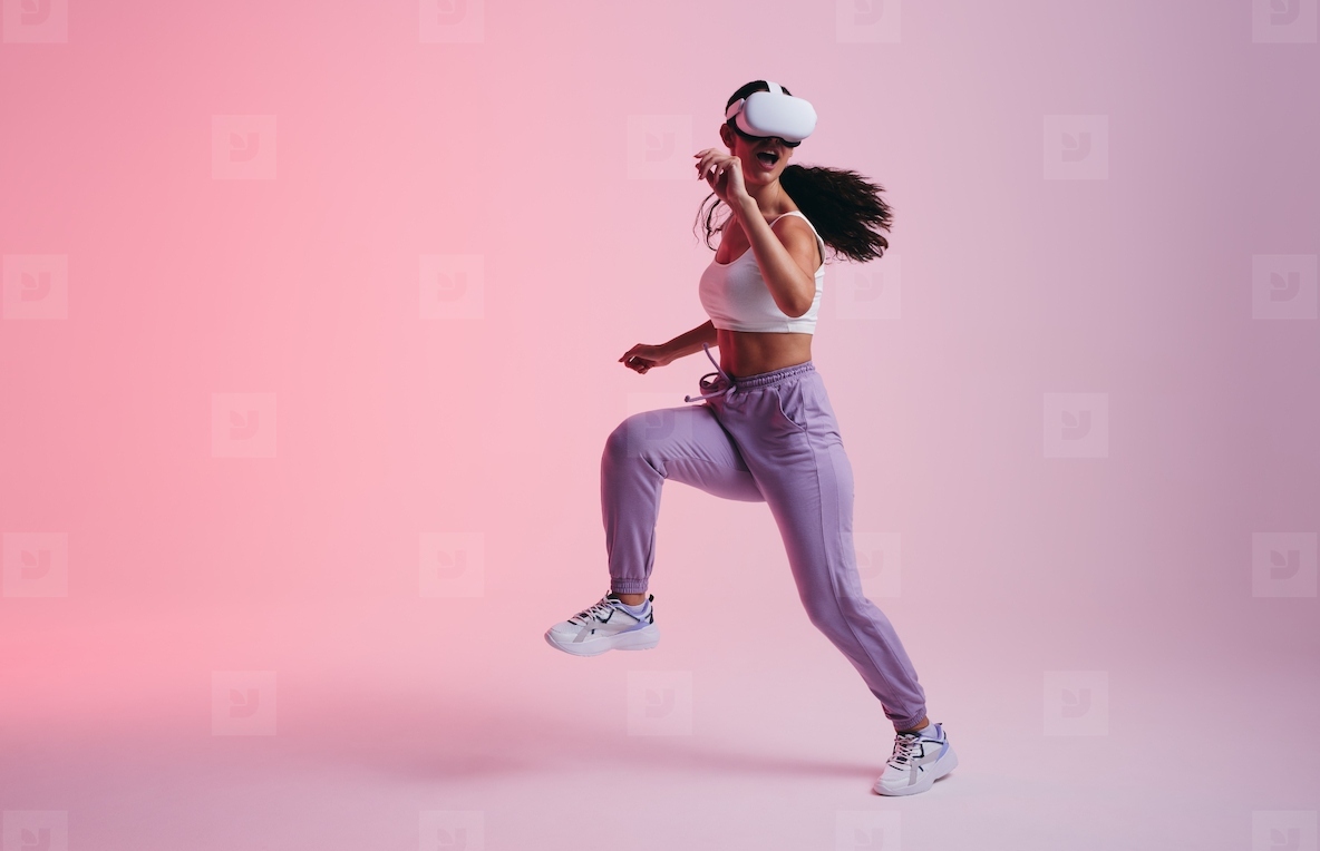 Young woman dancing in virtual reality