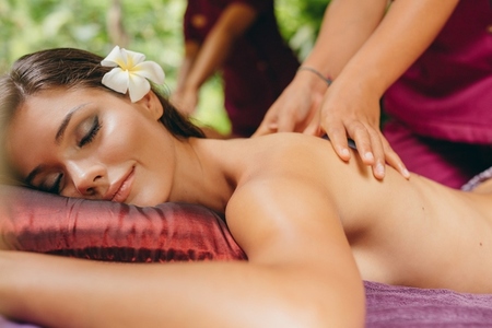 Attractive woman getting a massage at day spa