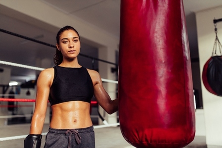 Female boxer looking at the camera in a fitness gym