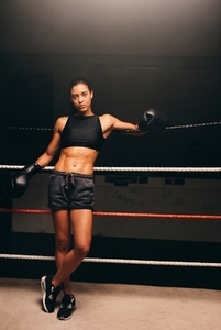 Fit young woman looking at the camera in a boxing ring