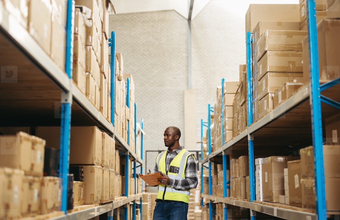 Young warehouse worker taking inventory in a logistics centre