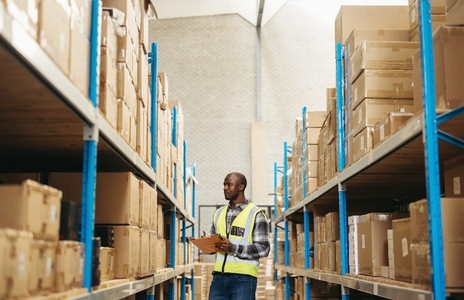 Young warehouse worker taking inventory in a logistics centre