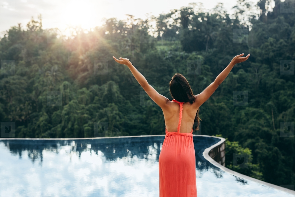 Woman enjoying tropical climate at luxury resort