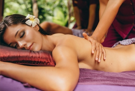 Young woman receiving back massage at day spa