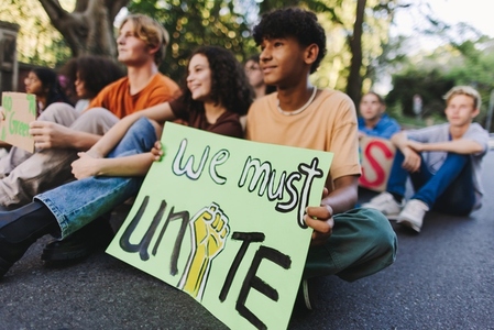 Teenage boy holding a poster at a climate protest