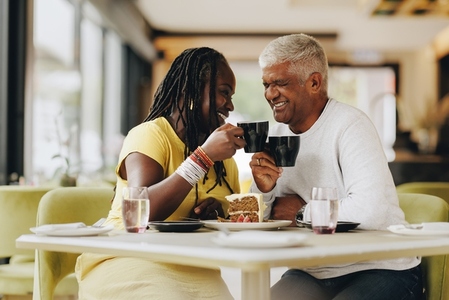 Mature couple enjoying themselves in a coffee shop