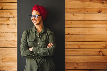 Cheerful female entrepreneur wearing a headscarf in an office