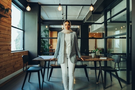 Confident businesswoman wearing a hijab in a modern office