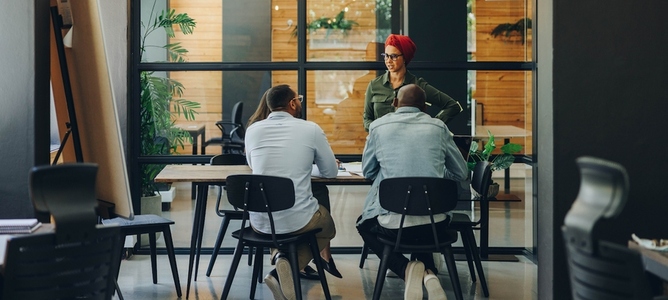 Businesswoman having a discussion with her team in an office