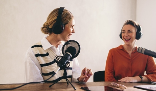 Happy podcast host interviewing a guest on her show