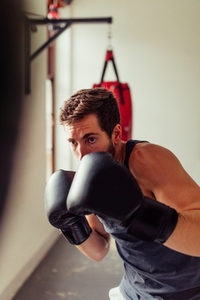 Solitary fighter training with boxing gloves