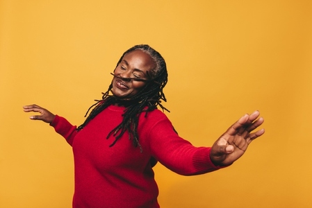 Joyful black woman dancing in a studio