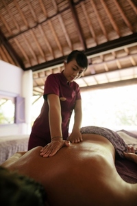 Man getting back massage at spa resort