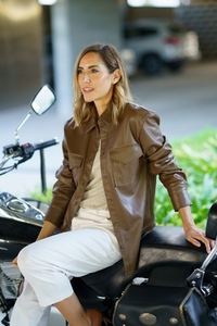 Stylish woman sitting on motorbike