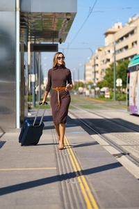 Businesswoman walking near tramway on street