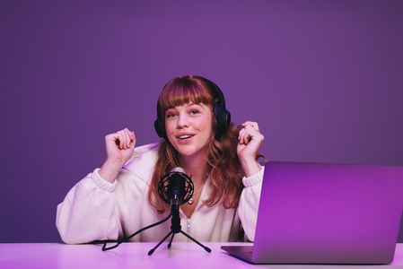Woman recording a live podcast in a studio