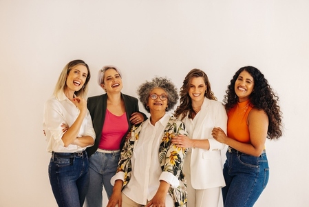 Diverse businesswomen smiling at the camera in an office