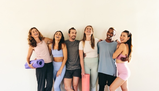 Group of happy friends standing together in a yoga studio