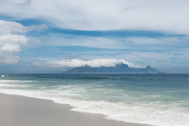 View mountains and clouds from the beach