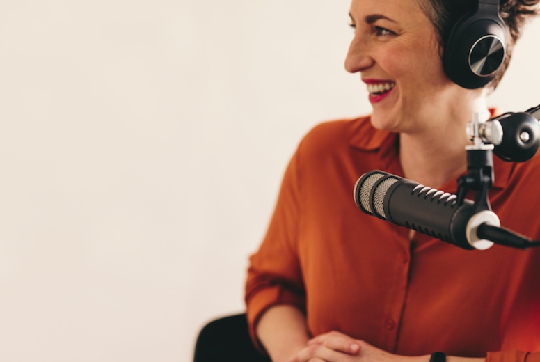 Cheerful woman interviewing a guest on her radio show