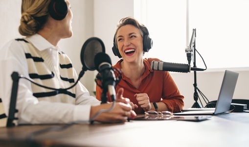 Podcasters laughing happily on their show