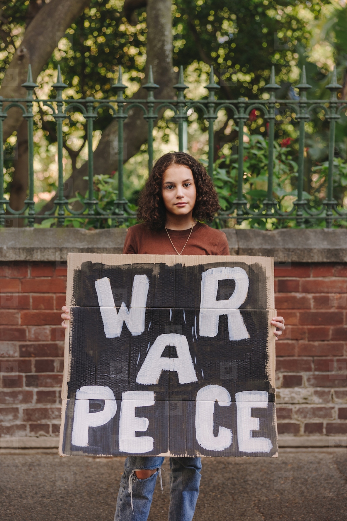 Teenage activist holding an anti war poster