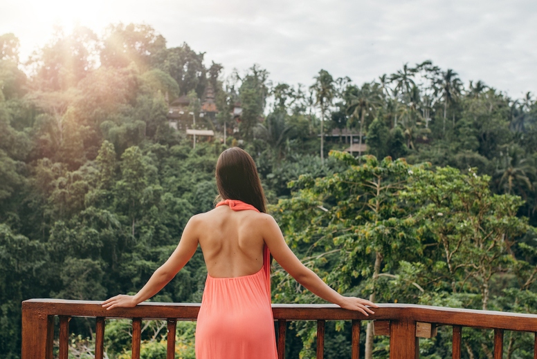Woman standing by a railing at luxury resort