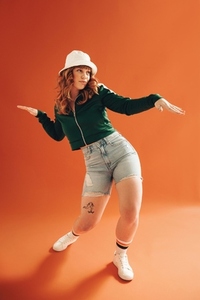 Vibrant young woman doing some dance moves in a studio