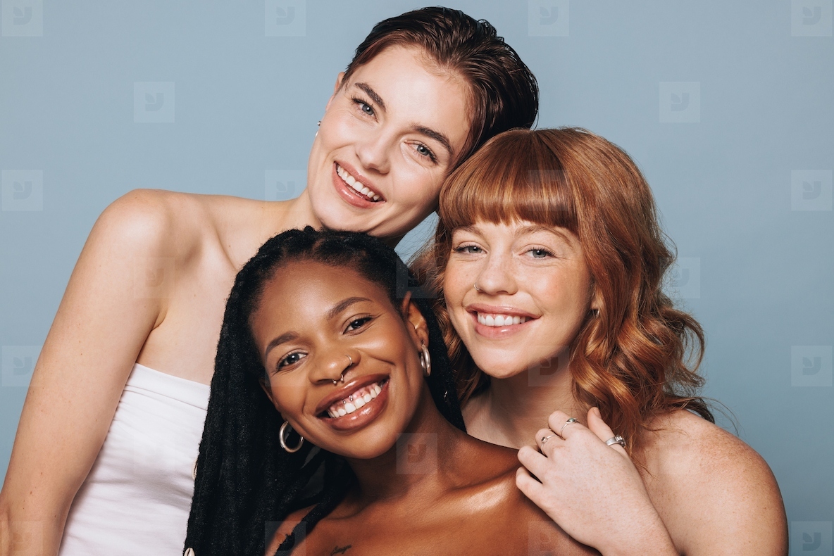 Portrait of women with different skin tones smiling at the camera